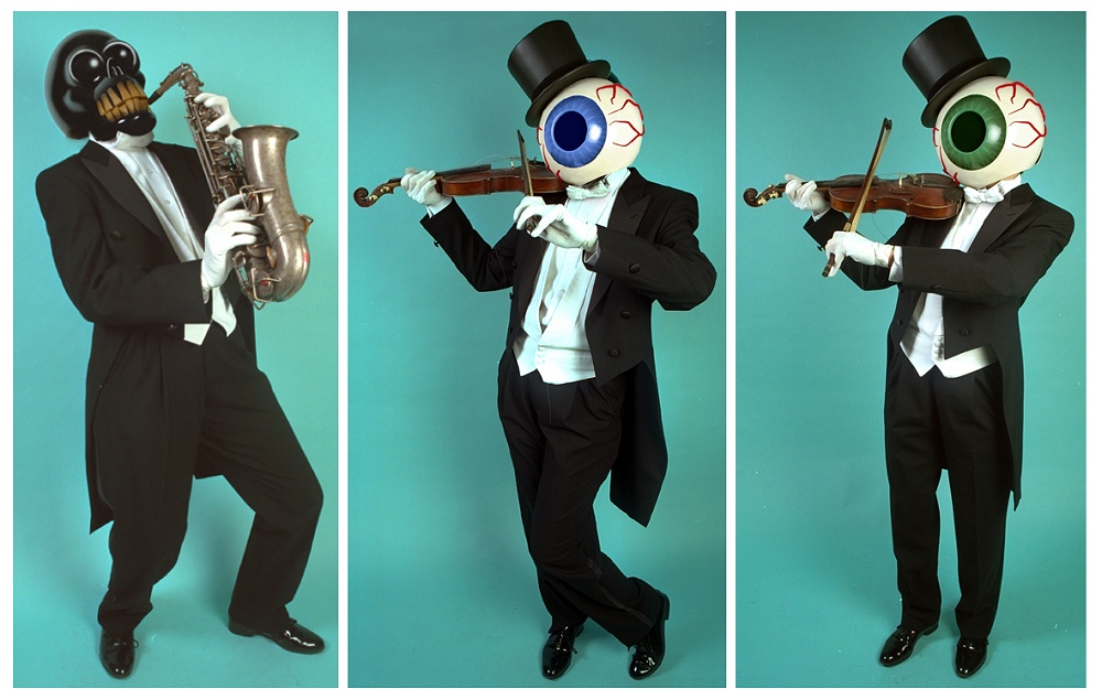 Mr. Skull playing a saxophone, while Mr. Blue and Mr. Green play violins.