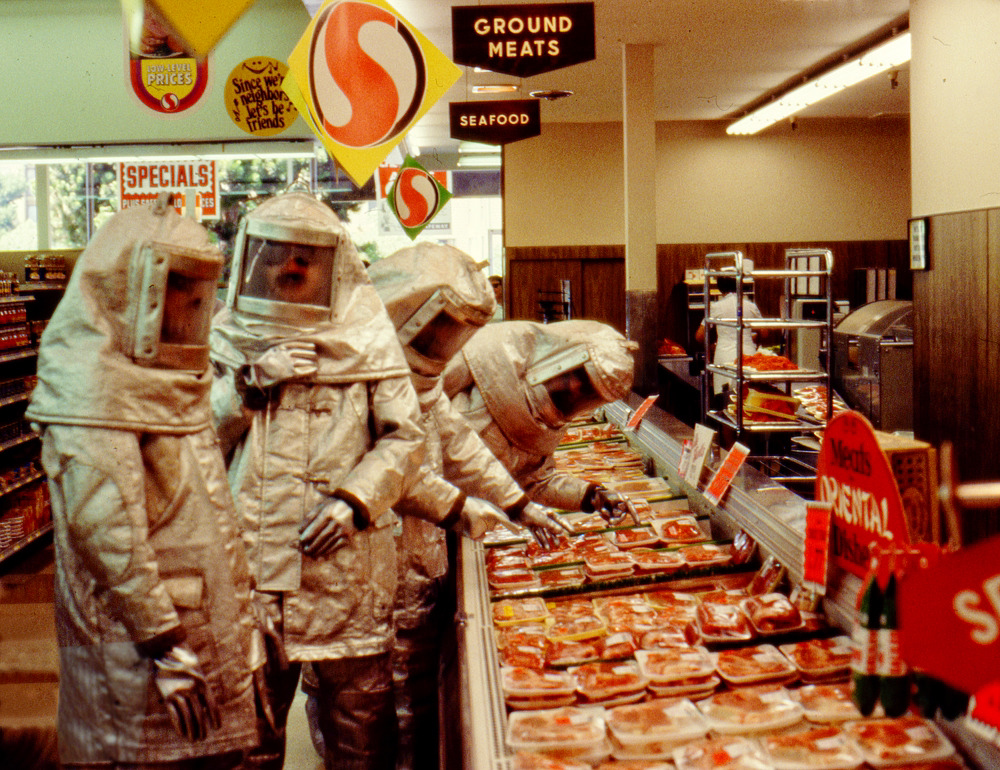 A picture made for the Commercial Album. The Residents are in hazmat suits in a grocery store, looking at the meat section.