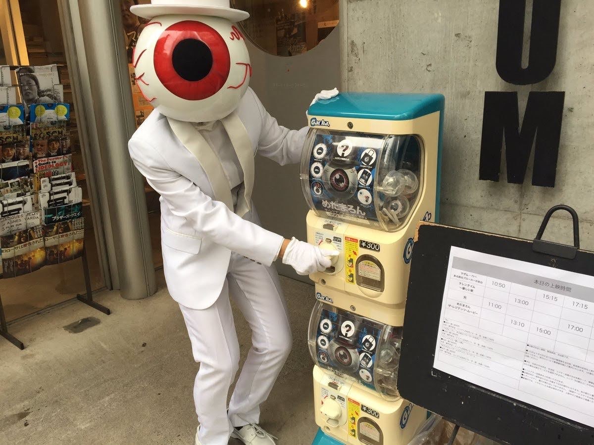 Mr. Red turning the dial of a Gachapon machine. This was taken during the promotion for their documentary, the Theory of Obscurity. 