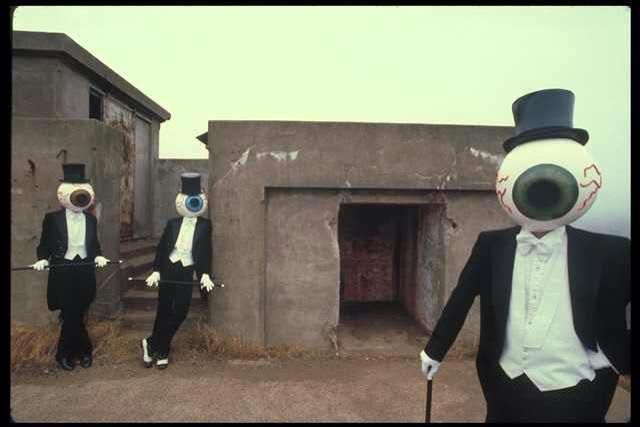 a picture of Mr. Brown, Mr. Green, and Mr. Blue in front of an abandoned doorway on a roof.
